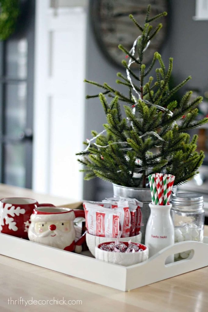 A white tray with a Christmas tree on it, perfect for adding some holiday cheer to your apartment kitchen.