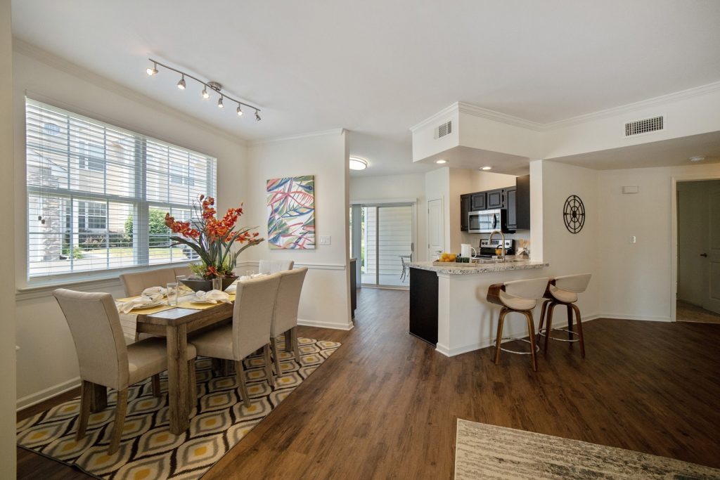 A kitchen and dining area with hardwood floors.