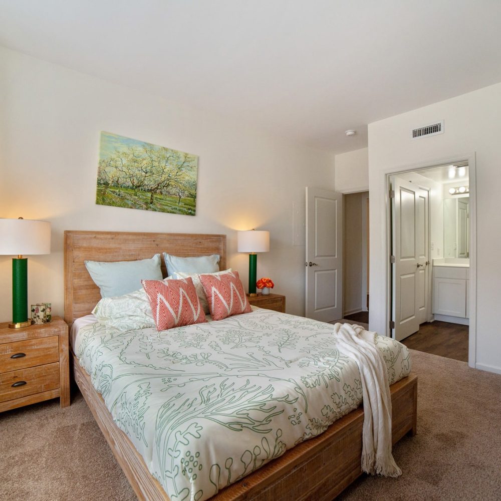 Your Two Bedroom Apartment includes a bedroom with a bed, dresser, and mirror.