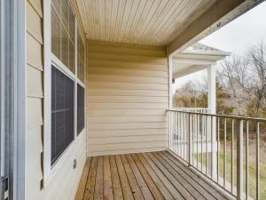 A media balcony with a wooden railing and a window.