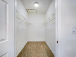 A media closet in a hallway with a door.