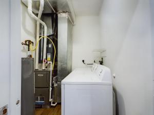 A media-filled laundry room with a washer and dryer.