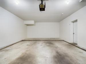 A media garage with a white floor and a ceiling fan.