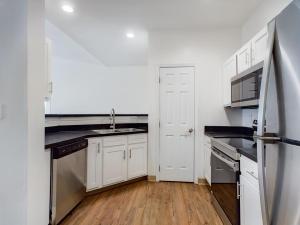 A media kitchen with white cabinets and stainless steel appliances.