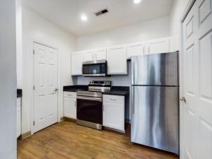 A media kitchen with white cabinets and stainless steel appliances.