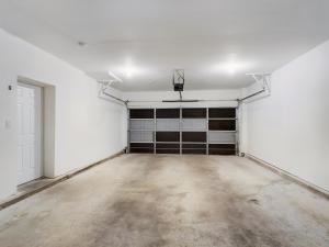 A media room with two garage doors.