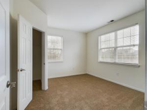 An empty room with white doors.